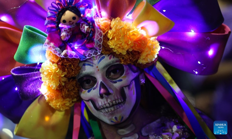 A reveller takes part in the Catrinas Parade in Mexico City, capital of Mexico, Oct. 25, 2026. The Catrinas Parade was held on Sunday ahead of the Day of the Dead. (Photo by Francisco Canedo/Xinhua)