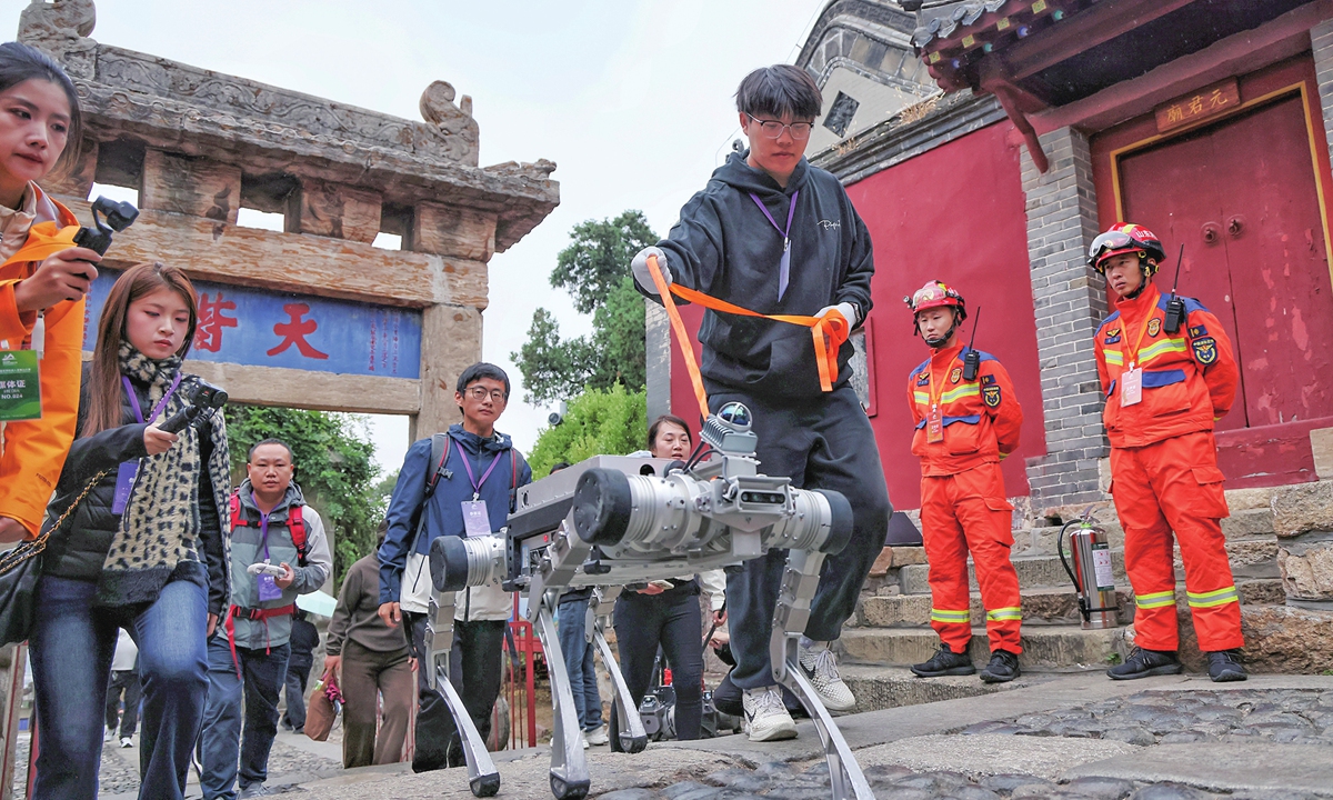 The qualifying phase of the inaugural CMG World Robot Mount Tai Competition kicks off on October 26, 2026 in Tai'an, East China's Shandong Province. Robots from multiple domestic teams are seen taking to the ancient mountain path, embarking on an intelligent trial that tests technology against physical endurance and algorithms against terrain. Photo: VCG