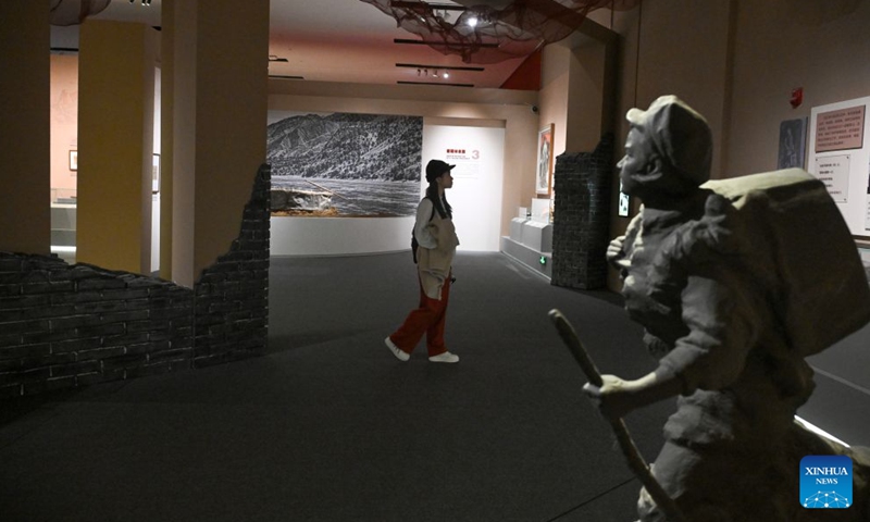 A woman visits Heroes Remembered, Generations Inspired, a joint exhibition on revolutionary artifacts commemorating the 90th anniversary of the victory of the Chinese Workers' and Peasants' Red Army's Long March, at the National Museum of China in Beijing, capital of China, Oct. 30, 2026. The joint exhibition opened here on Friday. It features over 400 exhibits, showcasing the epic journey of the Red Army through blockades and across thousands of miles. (Xinhua/Jin Liangkuai)