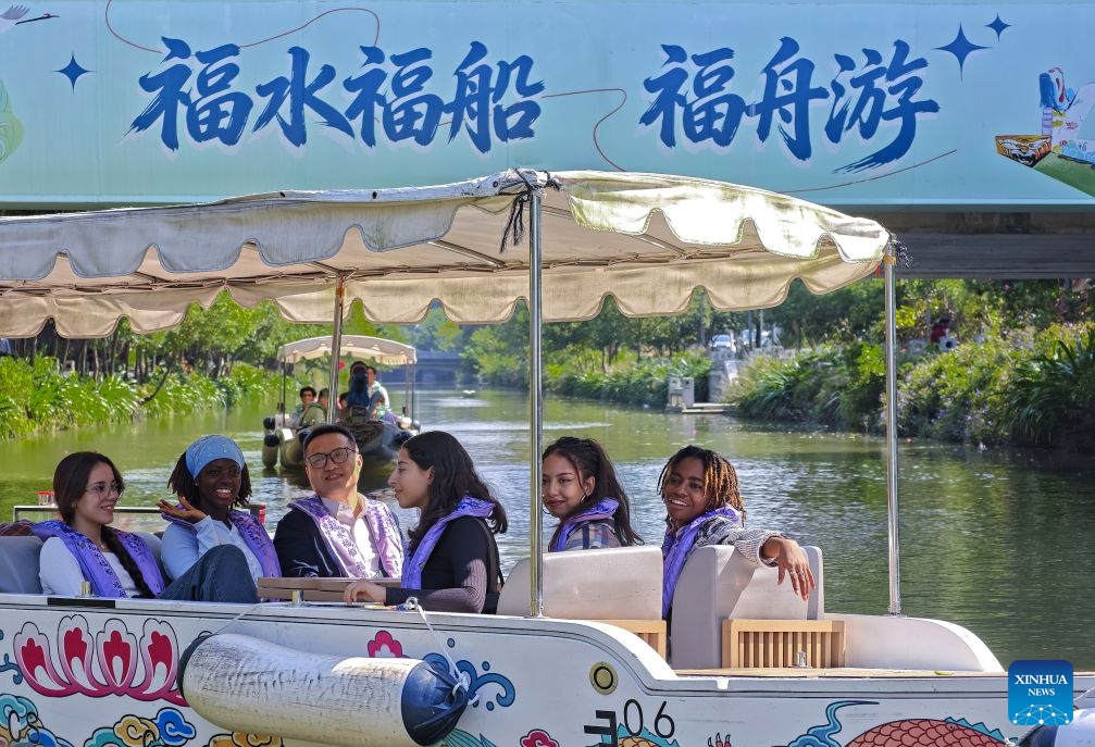 Overseas students take a boat to enjoy the scenery along a river-lake connecting route in Fuzhou, southeast China's Fujian Province, Oct. 30, 2026. Fuzhou, located on the coast of the East China Sea and the banks of the Minjiang River, is a renowned historical city with a history of over 2,200 years. Relying on its natural endowments and cultural heritage, Fuzhou has coordinated urban renewal, ecological governance, cultural heritage preservation and other aspects to promote high-quality and sustainable urban development. (Xinhua/Wei Peiquan)