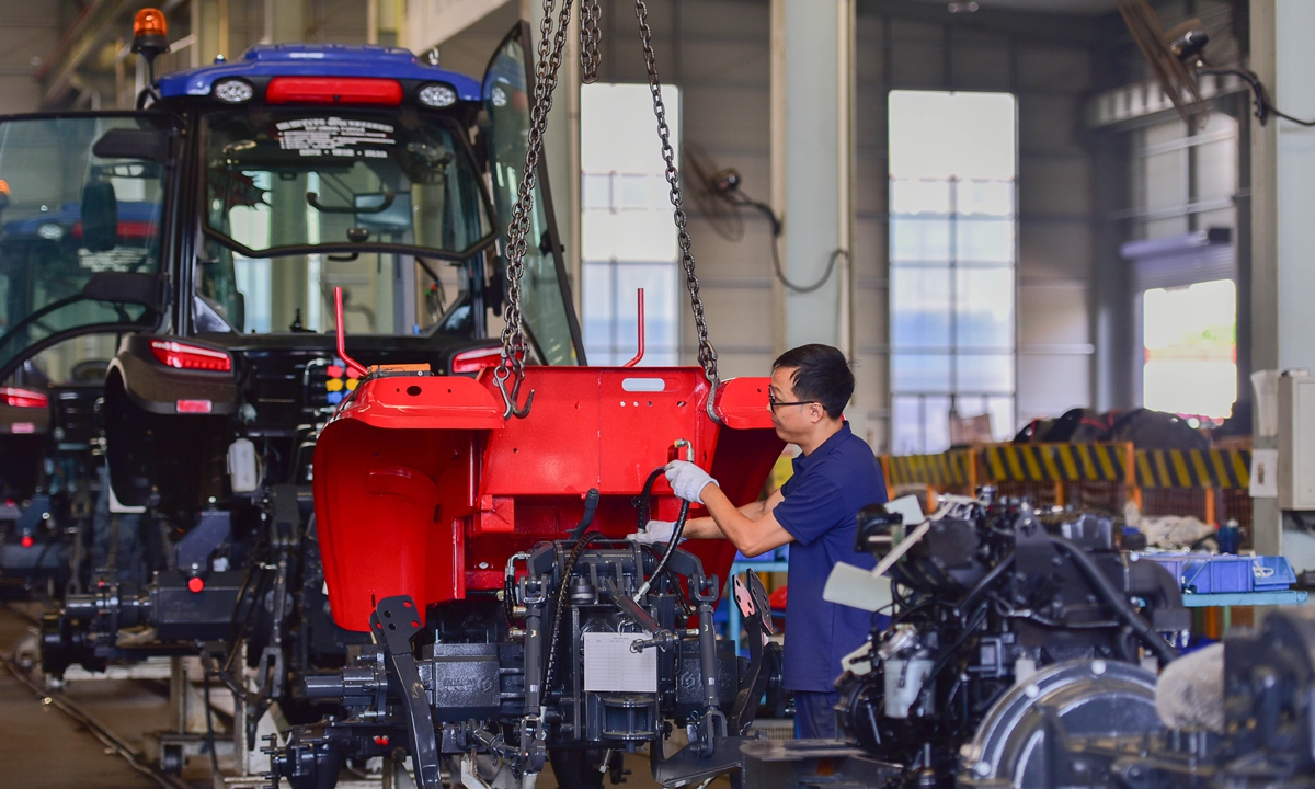 A worker assembles a tractor at a manufacturing plant in Caterpillar Industrial Park in Qingzhou, East China's Shandong Province, on September 27, 2026. Photo: VCG