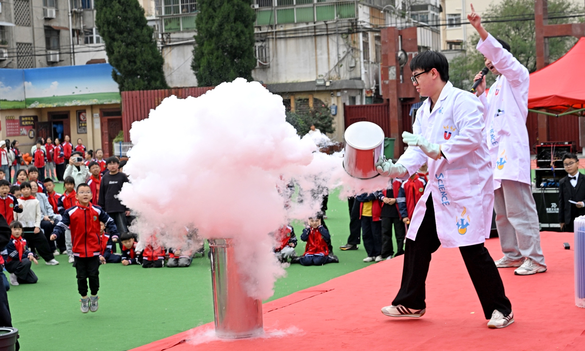 Students watch a liquid nitrogen experiment demonstration at a campus science festival in Huainan, East China's Anhui Province, on October 28, 2026. The white cloud forms as ultra-cold liquid nitrogen vaporizes rapidly, cooling ambient water vapor into tiny suspended water droplets. Photo: VCV
