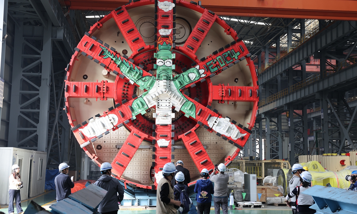 Visitors view a tunnel boring machine (TBM) at China Communications Construction Tianhe Machinery Equipment Manufacturing Co., Ltd. in Changshu, Jiangsu Province on October 30. The firm holds 389 valid patents, produces more than 160 TBMs annually, and its largest model reaches 18 meters in diameter. Photo: CNS Photo